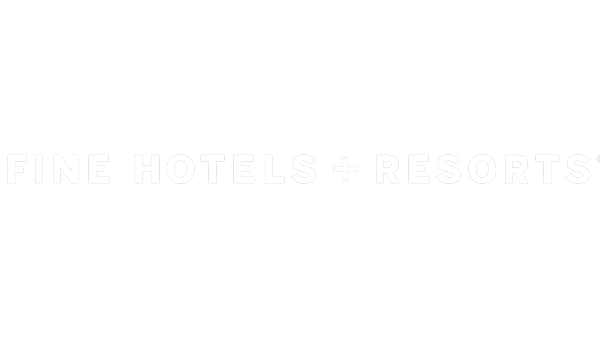 Logo Fine Hotels + Resorts white on grey background