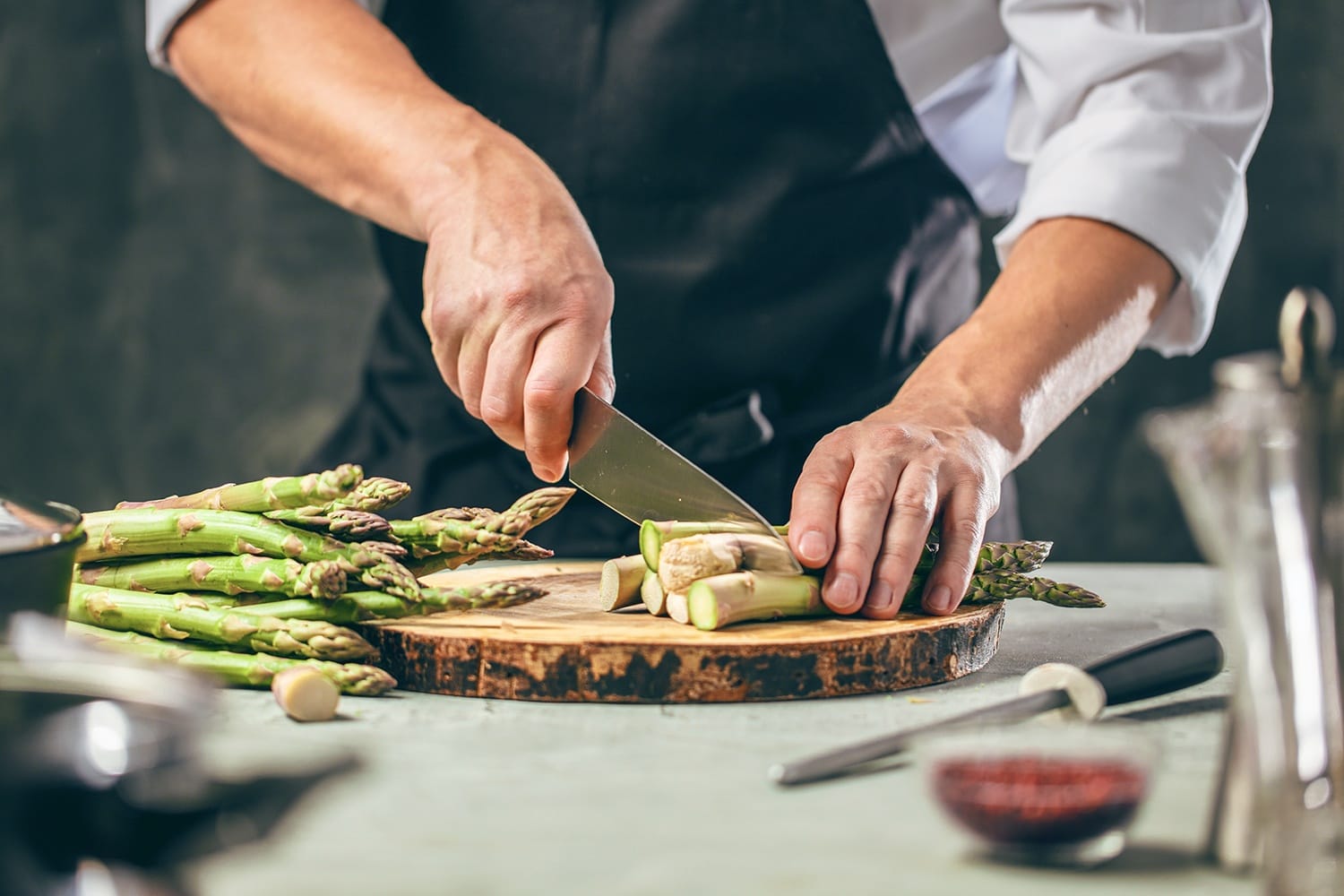 Chef cutting asparagus at Restaurant Hanse Stube