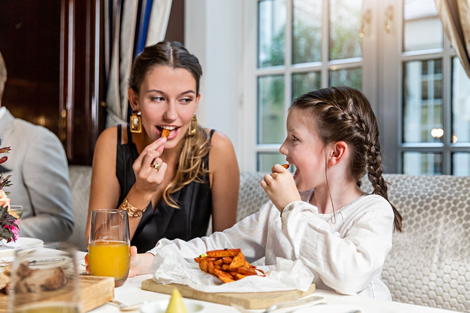 Young woman and child eating at Hanse Stube gourmet restaurant